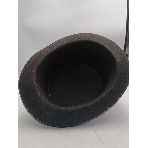 21 - Steampunk-inspired black felt top hat, embellished with feather plume, faux goggles, applied gear mo... 