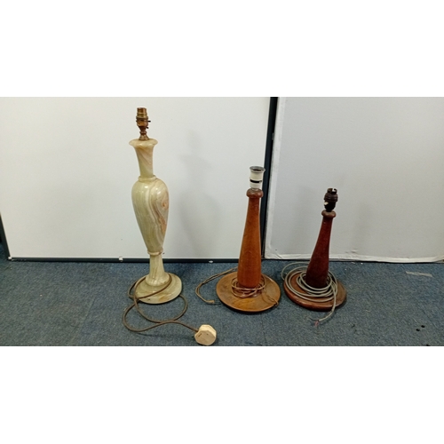 31 - A group of three table lamps, 20th century—one of baluster form in banded onyx with brass lampholder... 