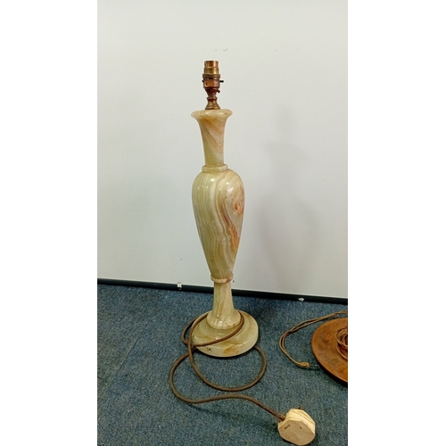 31 - A group of three table lamps, 20th century—one of baluster form in banded onyx with brass lampholder... 