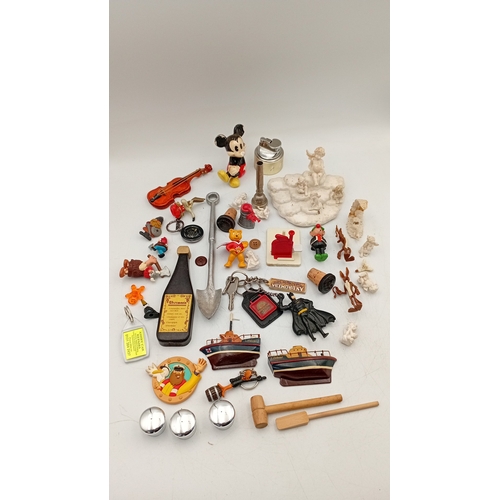 32 - An assortment of small collectibles and novelties, including a Simpsons metal tin, character figures... 
