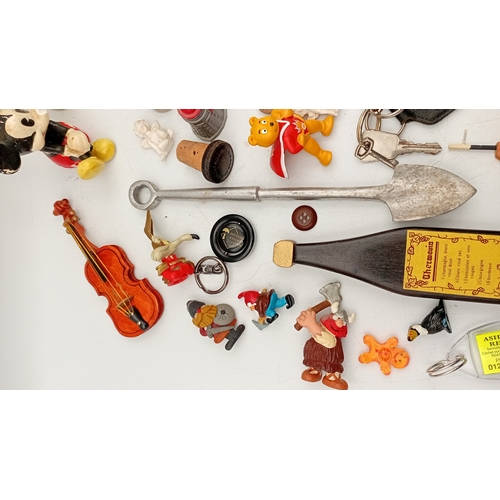 32 - An assortment of small collectibles and novelties, including a Simpsons metal tin, character figures... 