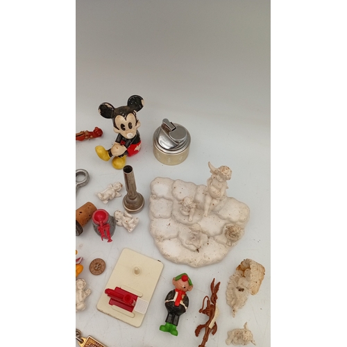 32 - An assortment of small collectibles and novelties, including a Simpsons metal tin, character figures... 