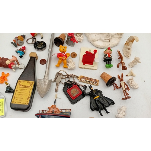 32 - An assortment of small collectibles and novelties, including a Simpsons metal tin, character figures... 