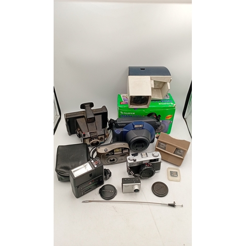 40 - A mixed group of photographic equipment including Fujifilm Instax 100 instant camera with box, Minol... 