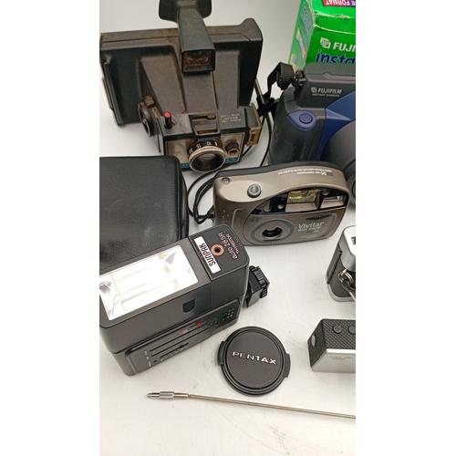 40 - A mixed group of photographic equipment including Fujifilm Instax 100 instant camera with box, Minol... 