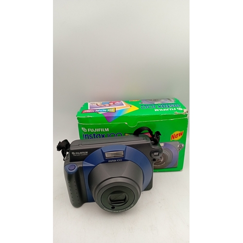 40 - A mixed group of photographic equipment including Fujifilm Instax 100 instant camera with box, Minol... 