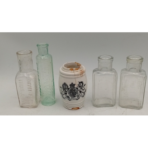 41 - A group of embossed glass bottles in aqua and clear, including stout, medicinal and rectangular form... 