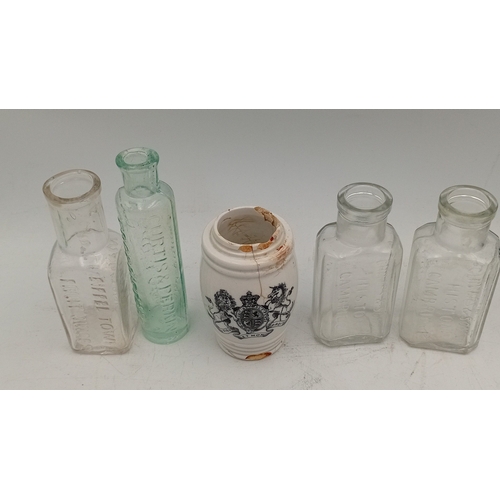 41 - A group of embossed glass bottles in aqua and clear, including stout, medicinal and rectangular form... 
