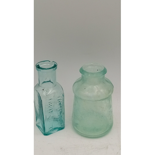 41 - A group of embossed glass bottles in aqua and clear, including stout, medicinal and rectangular form... 
