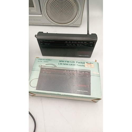 97 - A group of portable audio equipment comprising a Ferguson 3-band radio cassette recorder, model 3T21... 