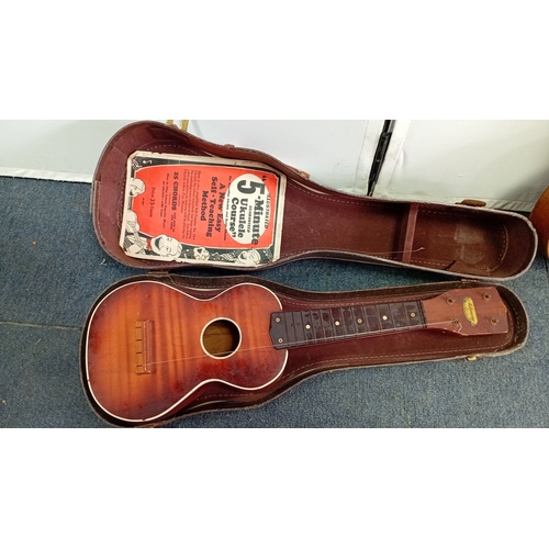 69 - A group of fretted instruments comprising a Harmony soprano ukulele with sunburst finish, a banjo-uk... 
