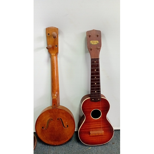 69 - A group of fretted instruments comprising a Harmony soprano ukulele with sunburst finish, a banjo-uk... 