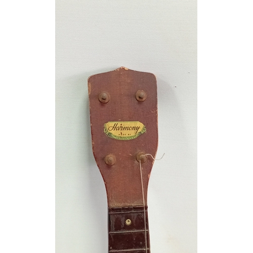 69 - A group of fretted instruments comprising a Harmony soprano ukulele with sunburst finish, a banjo-uk... 