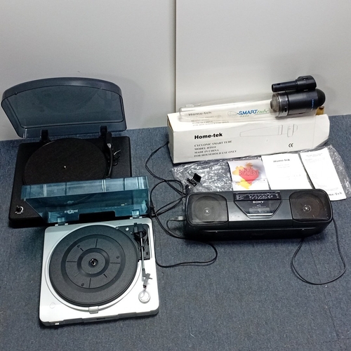 73 - A mixed group of domestic audio and household electronics, comprising two portable record players wi... 