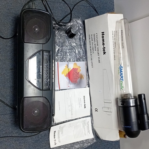 73 - A mixed group of domestic audio and household electronics, comprising two portable record players wi... 