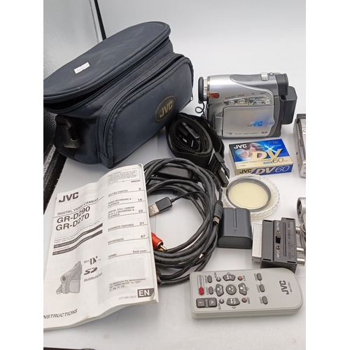82 - A quantity of consumer digital video cameras, including a JVC MiniDV camcorder (GR-D290/GR-D270), a ... 