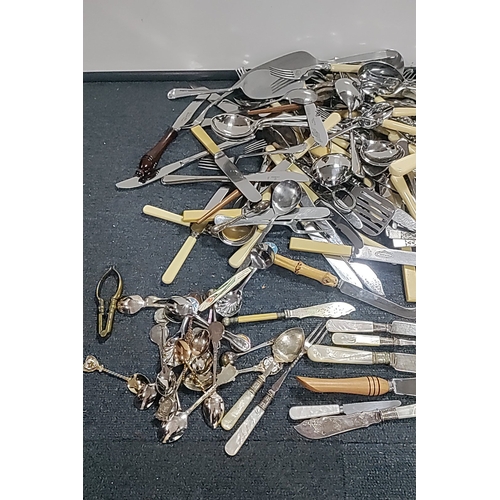 48 - A quantity of mixed flatware and serving implements, including silver plated and stainless steel cut... 