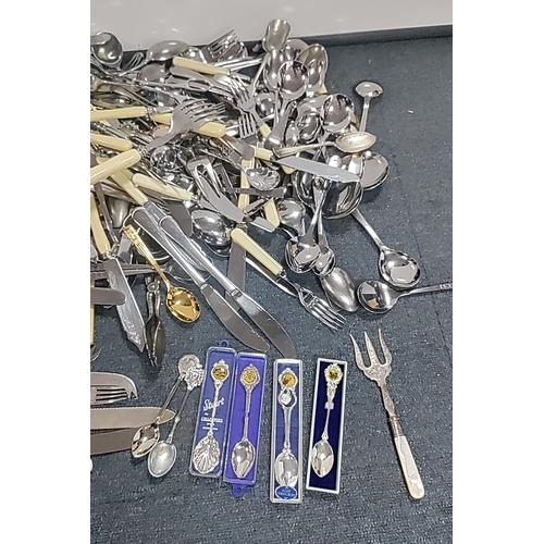 48 - A quantity of mixed flatware and serving implements, including silver plated and stainless steel cut... 