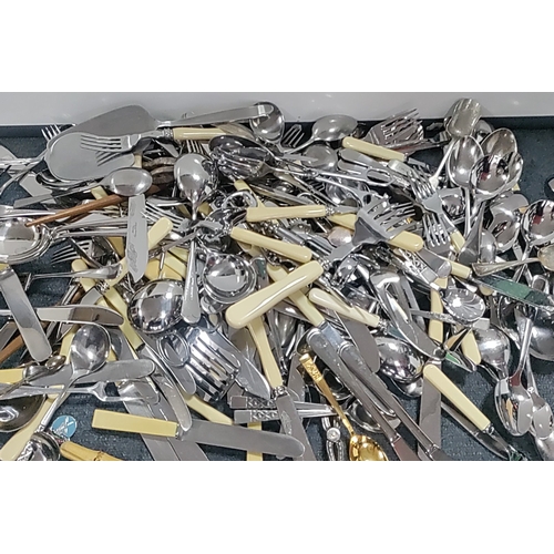 48 - A quantity of mixed flatware and serving implements, including silver plated and stainless steel cut... 