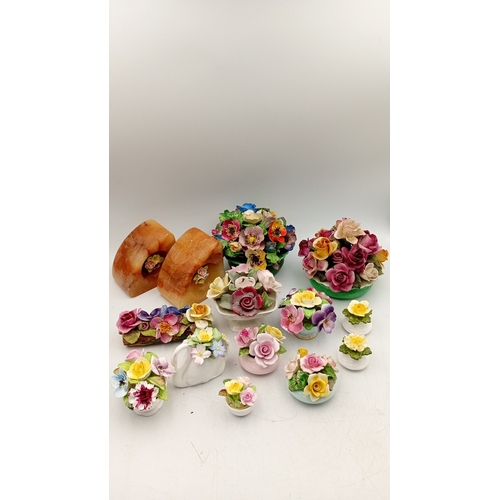 50 - A group of assorted porcelain floral encrusted ornaments and posy holders, including miniature vases... 