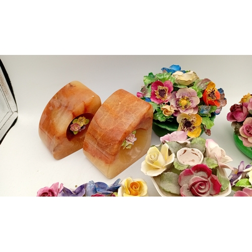 50 - A group of assorted porcelain floral encrusted ornaments and posy holders, including miniature vases... 