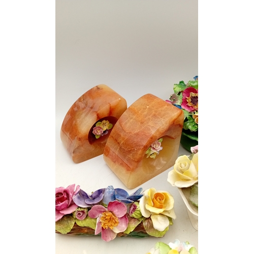 50 - A group of assorted porcelain floral encrusted ornaments and posy holders, including miniature vases... 