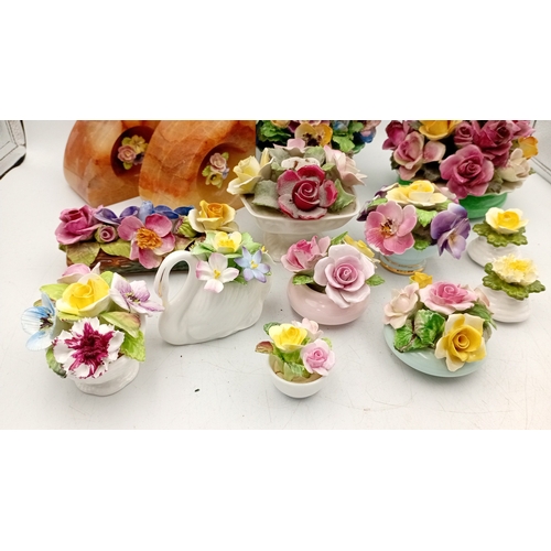 50 - A group of assorted porcelain floral encrusted ornaments and posy holders, including miniature vases... 