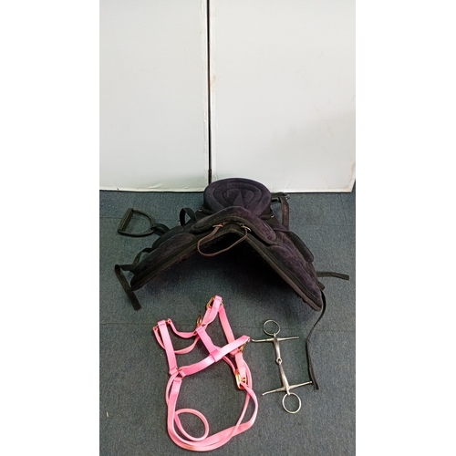 53 - An assortment of equestrian tack comprising a black synthetic treeless-style saddle with integrated ... 