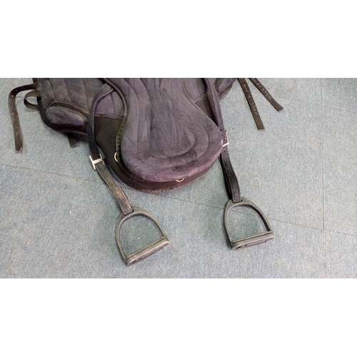 53 - An assortment of equestrian tack comprising a black synthetic treeless-style saddle with integrated ... 