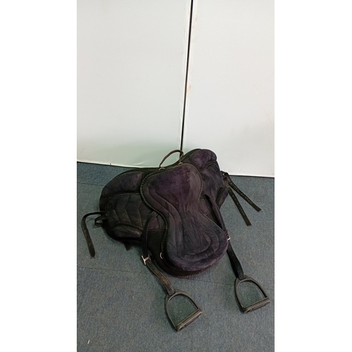 53 - An assortment of equestrian tack comprising a black synthetic treeless-style saddle with integrated ... 