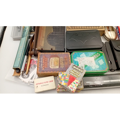 54 - A mixed lot of small ephemera and desk accessories, including a guillotine paper trimmer, playing ca... 