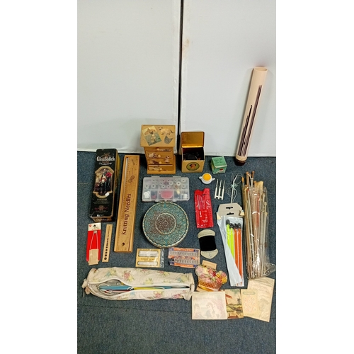 56 - A mixed group of sewing and knitting requisites, including a cat-decorated wooden drawer box, tins, ... 