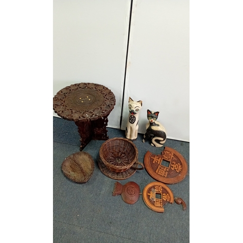 59 - A mixed decorative group comprising a carved hardwood occasional table with pierced foliate top and ... 