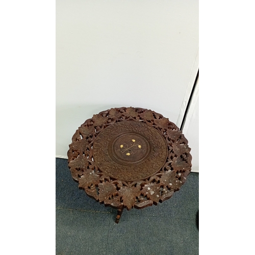 59 - A mixed decorative group comprising a carved hardwood occasional table with pierced foliate top and ... 