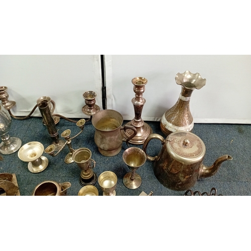 61 - A mixed lot of silver-coloured metalware and flatware, including a lidded teapot, goblets, candlesti... 