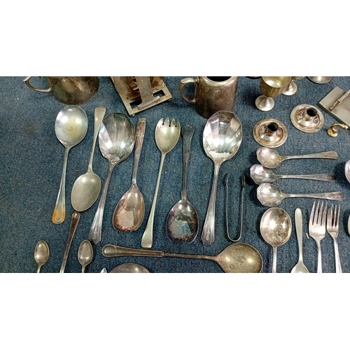 61 - A mixed lot of silver-coloured metalware and flatware, including a lidded teapot, goblets, candlesti... 