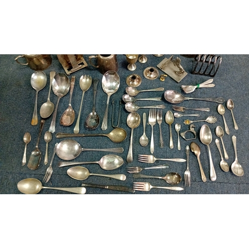 61 - A mixed lot of silver-coloured metalware and flatware, including a lidded teapot, goblets, candlesti... 