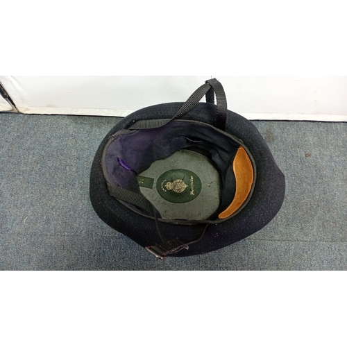 62 - British police custodian helmet of domed black felted construction, with blue-and-white chequered ba... 
