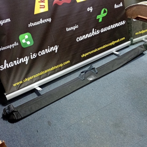 63 - Freestanding retractable roller banner, printed with UK Personal Cannabis Cup logo and cannabis-awar... 