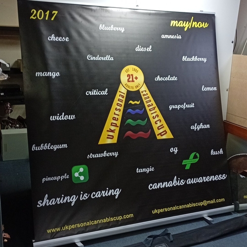 63 - Freestanding retractable roller banner, printed with UK Personal Cannabis Cup logo and cannabis-awar... 