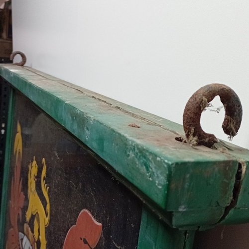 106 - A vintage painted double sided wooden pub hanging signboard, with green moulded frame and iron suspe... 