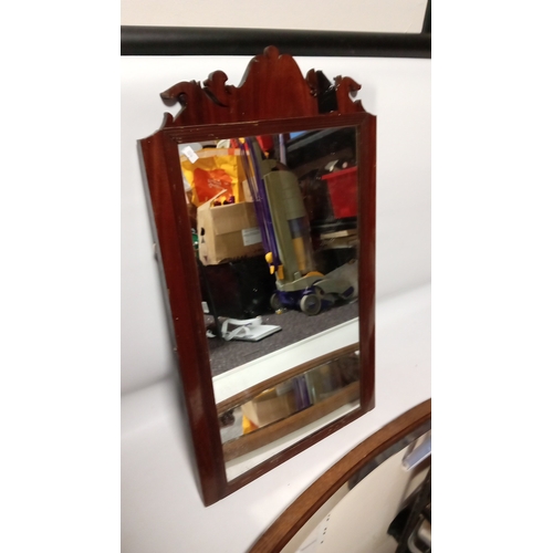 114 - Late Victorian mahogany wall mirror, the rectangular plate within a moulded frame surmounted by a sc... 