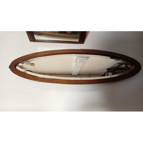 114 - Late Victorian mahogany wall mirror, the rectangular plate within a moulded frame surmounted by a sc... 