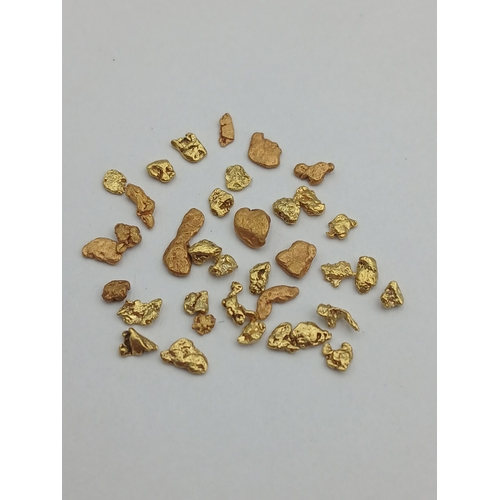 394 - A collection of tested 18ct gold nuggets. Total weight 2.07g