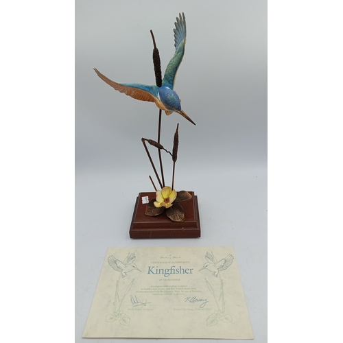 Danbury Mint ‘Kingfisher’—a foundry-cast bronze bird sculpture with hand-painted kingfisher in flight above bronzed cattails and water-lily, mounted on a stepped wooden plinth; accompanied by a printed certificate of authenticity. Small repairs to wings. Height 12 3/4 inches x Width 4 3/4 inches x Depth 4 inches.