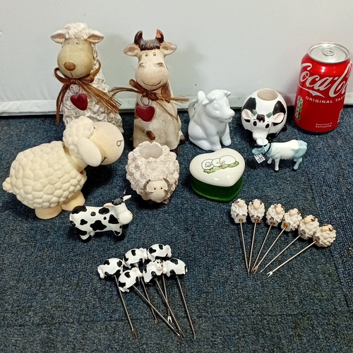 63 - A collection of novelty farm-animal ornaments in painted resin and ceramic, including cow and sheep ... 