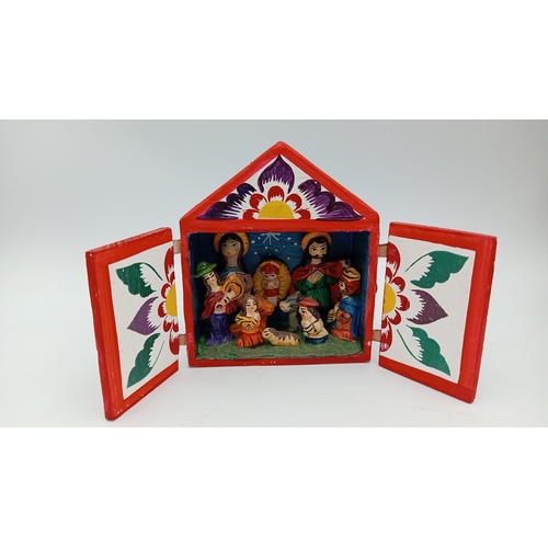 64 - A collection of devotional and souvenir items including polychrome resin figures, a wooden crucifix,... 