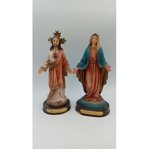 64 - A collection of devotional and souvenir items including polychrome resin figures, a wooden crucifix,... 