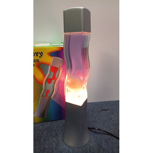 66 - A pair of “Groovy Motion Lamp” table lamps, each with a square-section base and cap framing a waiste... 