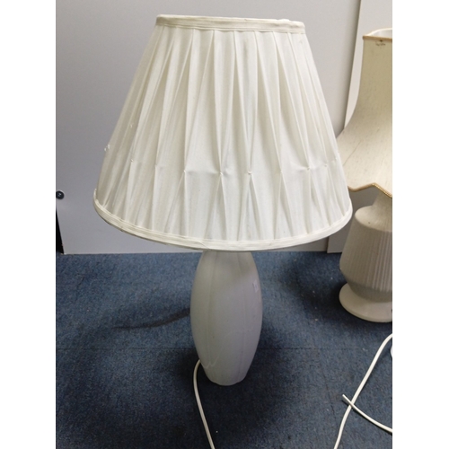 71 - A group of three electric table lamps comprising two white marble-effect baluster lamps with pleated... 